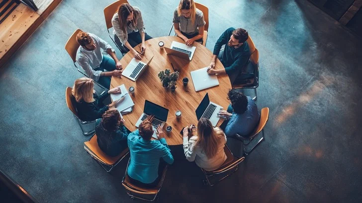 Office team participating in a structured group activity session around a shared table